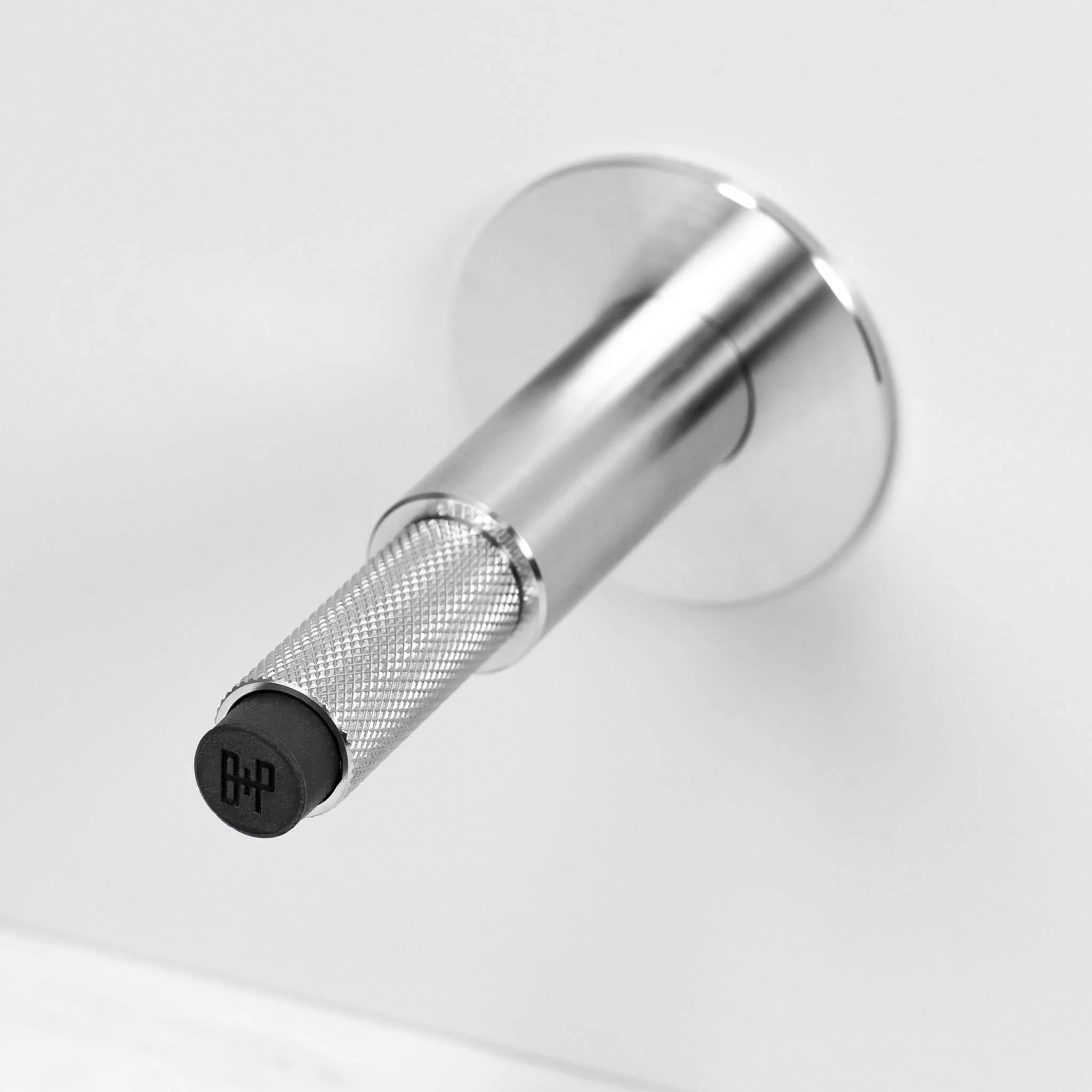Wall Mounted Door Stop in Solid Metal with Cross Knurl Pattern