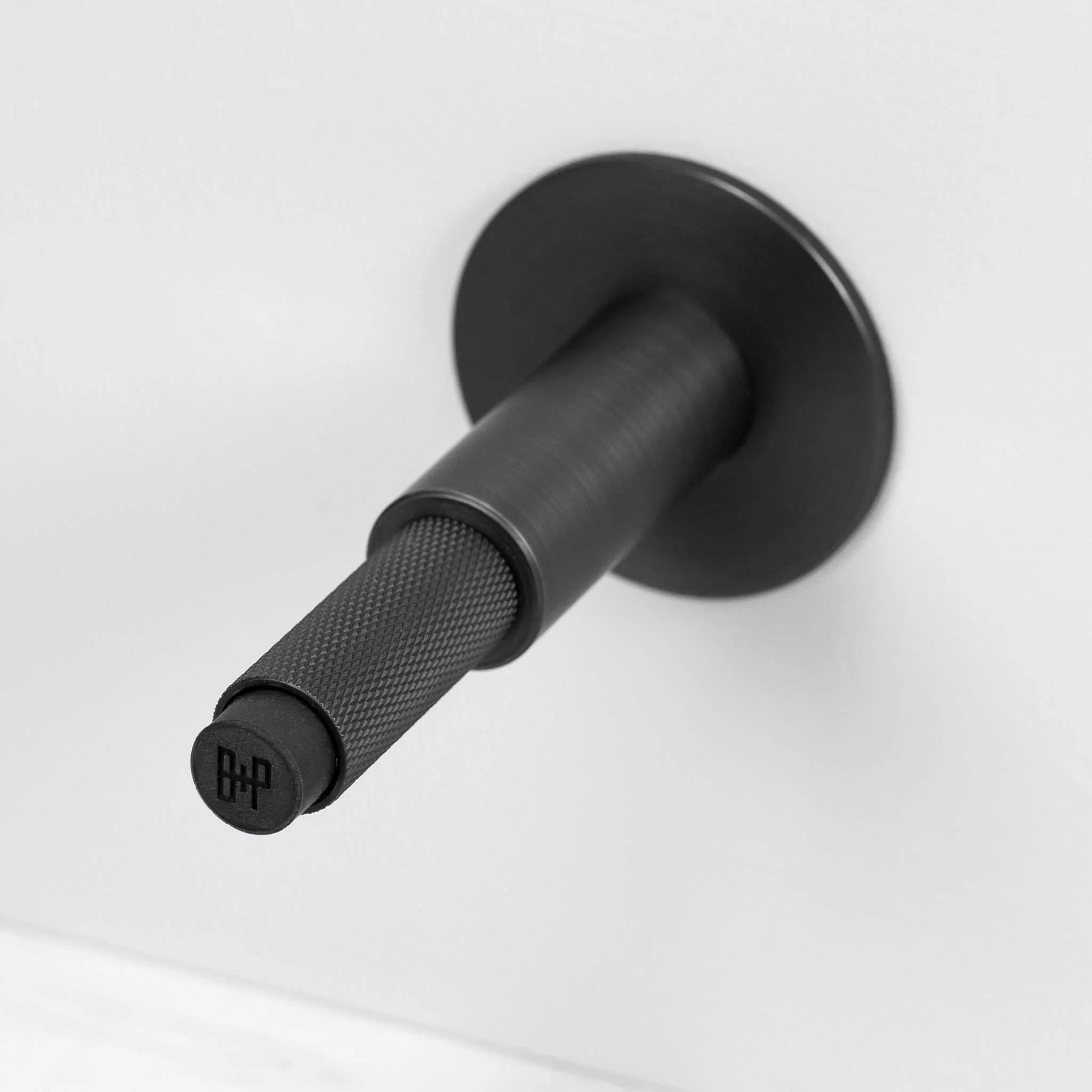 Wall Mounted Door Stop in Solid Metal with Cross Knurl Pattern