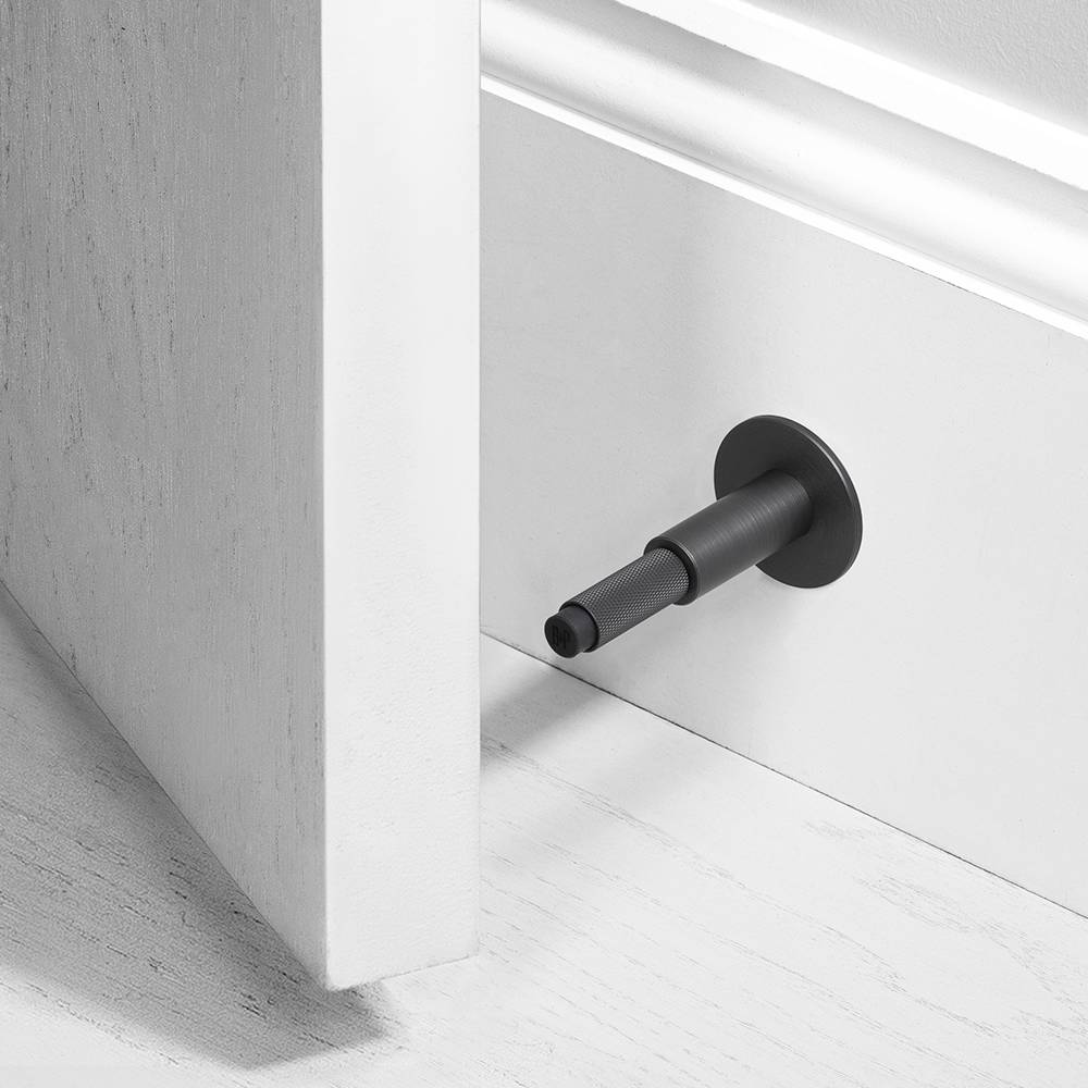 Wall Mounted Door Stop in Solid Metal with Cross Knurl Pattern