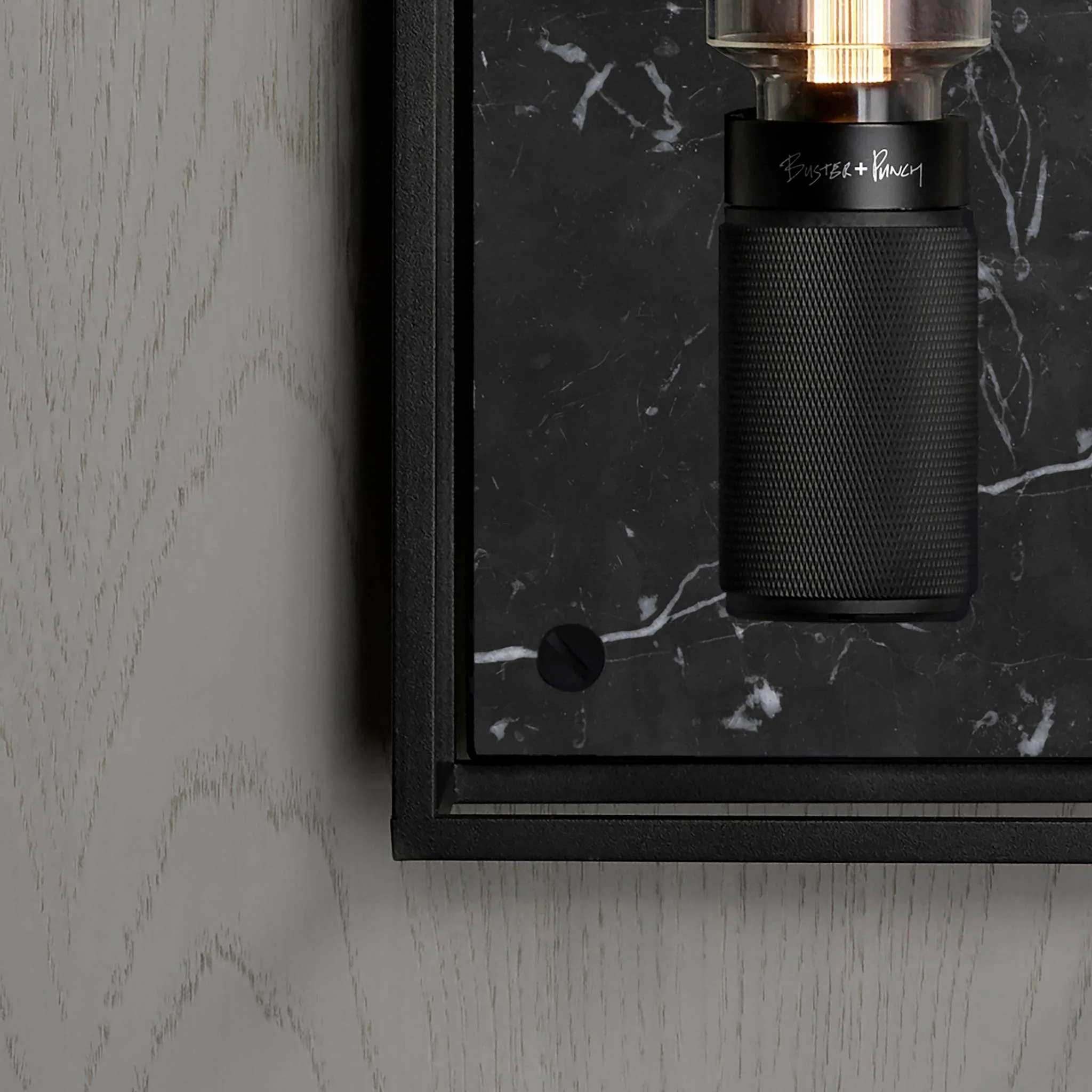 Caged Wall Large Matte Black Wall Light Frames the Buster Bulb