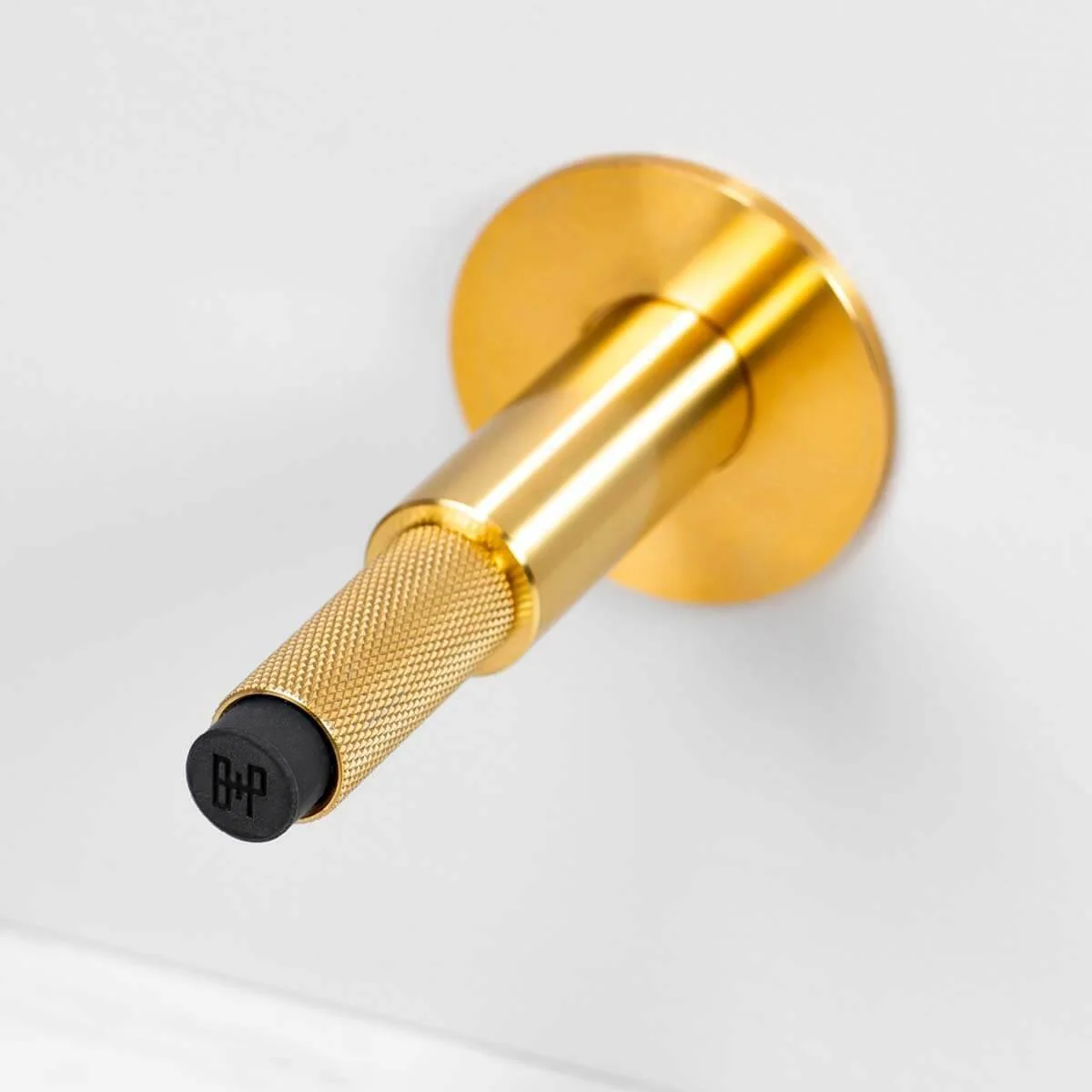 Wall Mounted Door Stop in Solid Metal with Cross Knurl Pattern