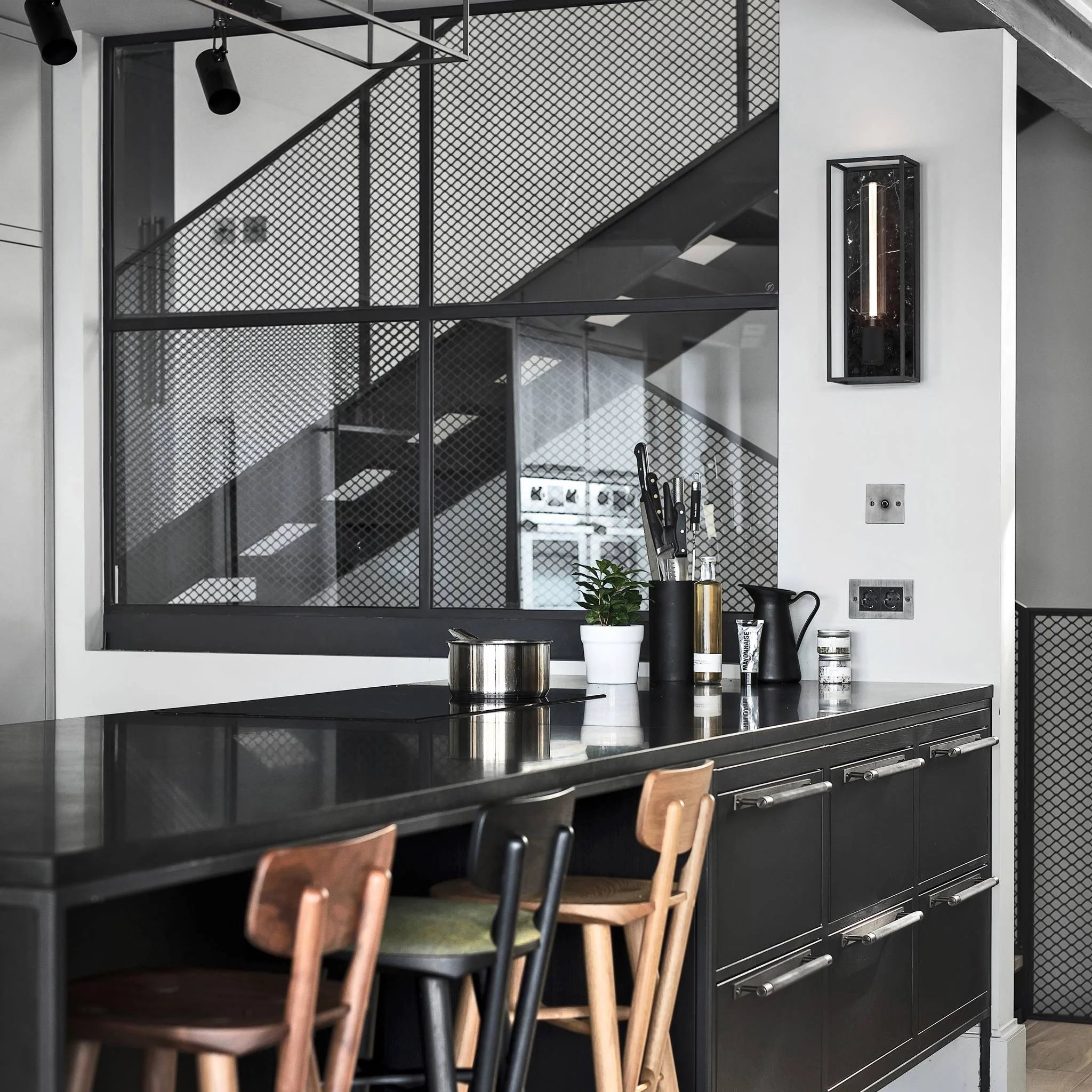 Caged Wall Large Matte Black Wall Light Frames the Buster Bulb