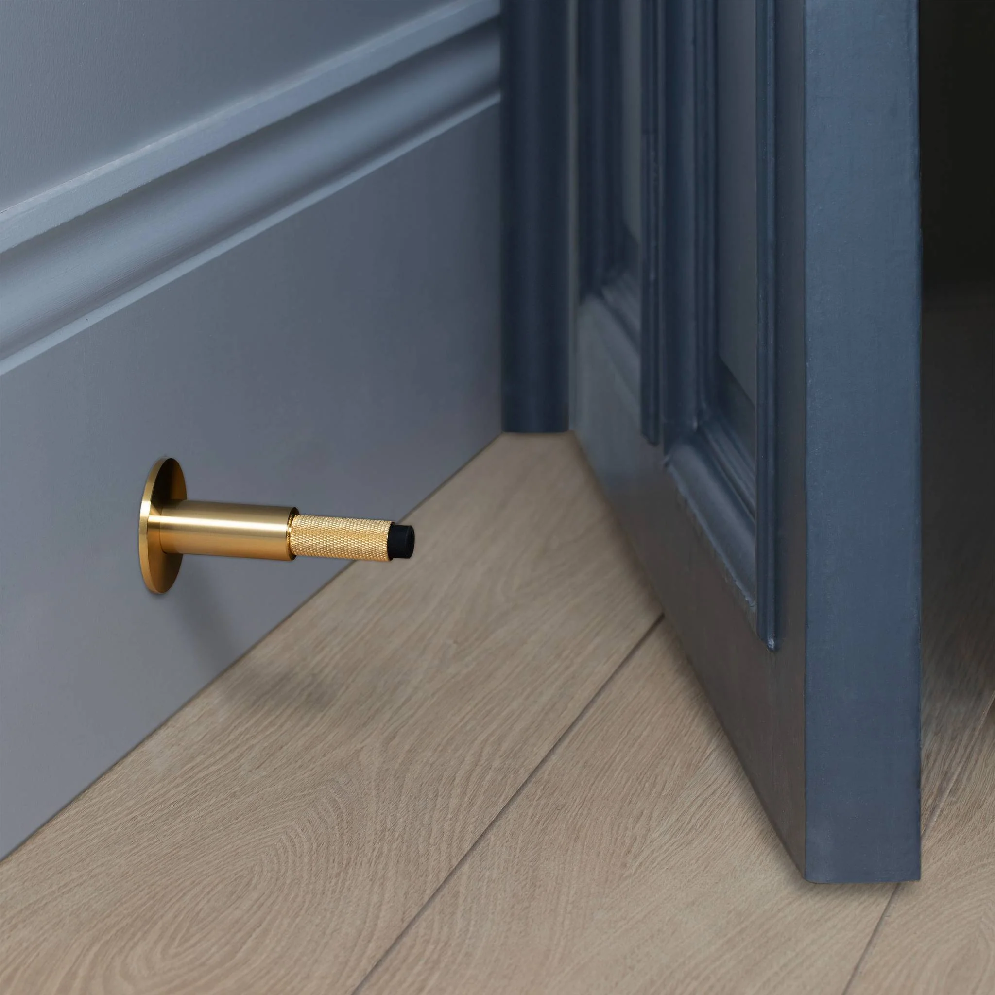 Wall Mounted Door Stop in Solid Metal with Cross Knurl Pattern